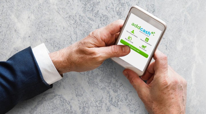 An AddCash image of hands holding a mobile phone using the AddCash solution on screen.